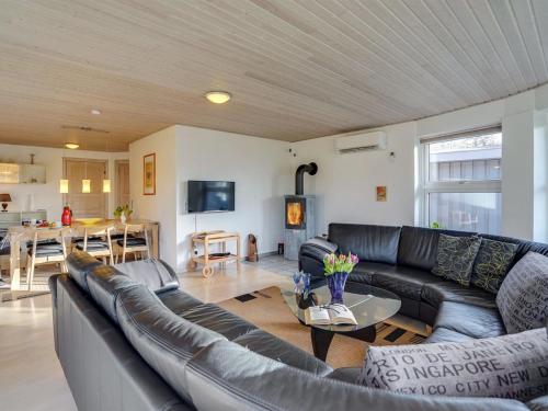 a living room with a couch and a table at Holiday Home Wyatt - 30km from the sea by Interhome in Toftlund