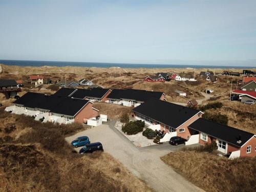 an aerial view of a house with cars parked in a field at Apartment Soufiane - 100m from the sea by Interhome in Vejers Strand