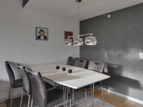 a white table and chairs in a room at Apartment Soufiane - 100m from the sea by Interhome in Vejers Strand