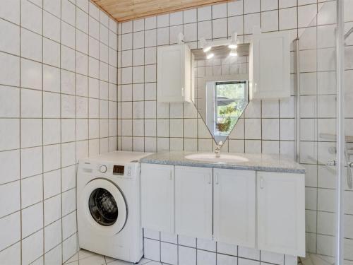 a laundry room with a washing machine and a window at Holiday Home Jonni - 15km from the sea by Interhome in Skærbæk
