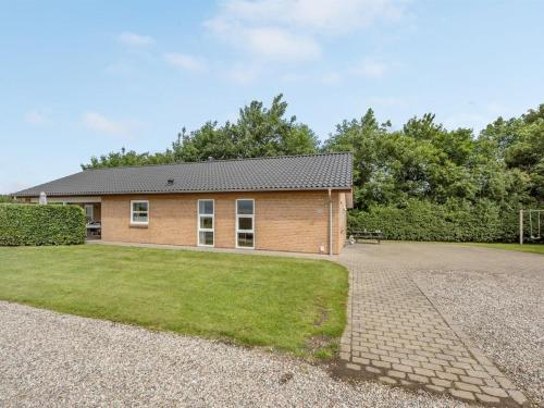 a house with a gravel driveway in front of it at Holiday Home Najdenka - 25km from the sea by Interhome in Toftlund
