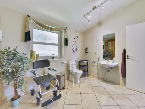 a bathroom with a toilet and a sink at Holiday Home Najdenka - 25km from the sea by Interhome in Toftlund