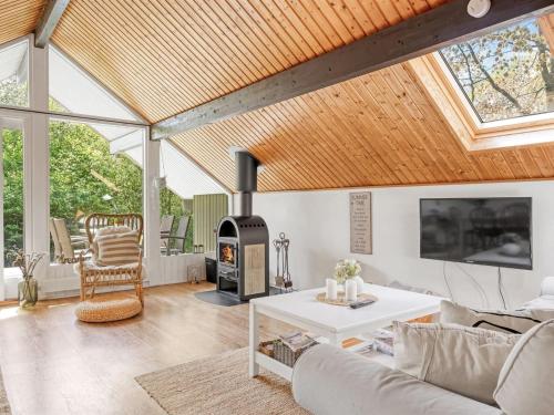 a living room with a couch and a wood stove at Holiday Home Hilla - 31km from the sea by Interhome in Toftlund