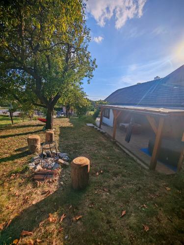 a campsite with a tree and a tent at Ondrašovská skala in Ondrašová