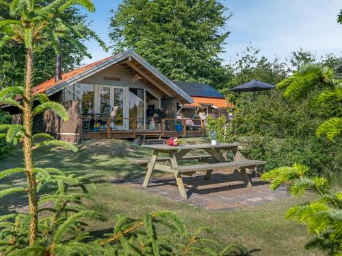 a picnic table in front of a house at Holiday Home Tecla - 12km from the sea by Interhome in Oksbøl