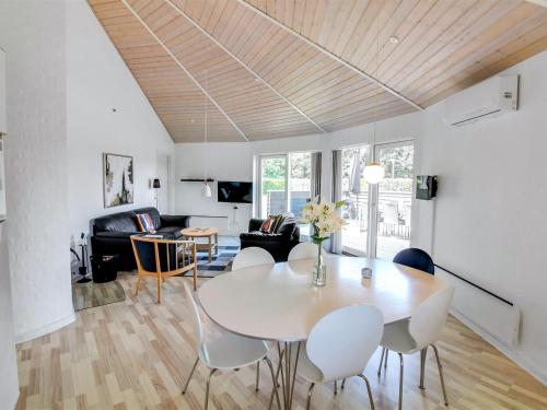a living room with a white table and chairs at Holiday Home Jani - 25km from the sea by Interhome in Toftlund