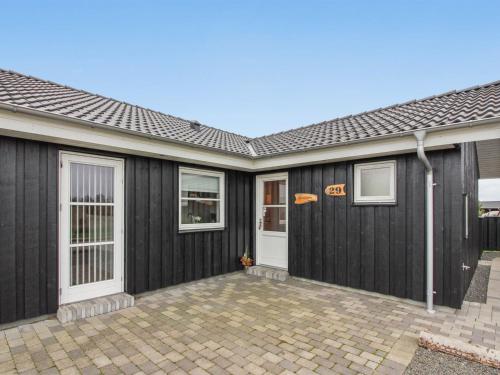 a house with a black garage at Holiday Home Saara - 700m to the inlet by Interhome in Tarm