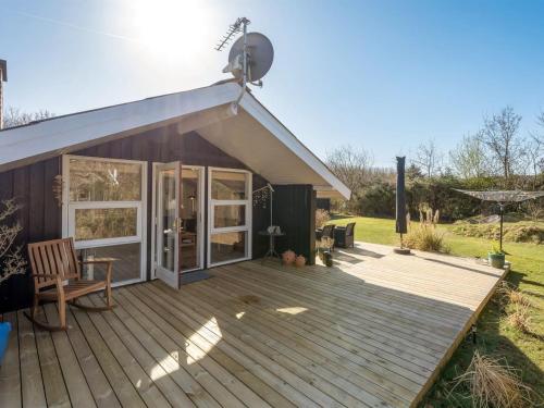 a house with a deck and a satellite at Holiday Home Gunde - 300m to the fjord by Interhome in Hemmet