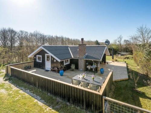 a home with a deck and a house at Holiday Home Gunde - 300m to the fjord by Interhome in Hemmet