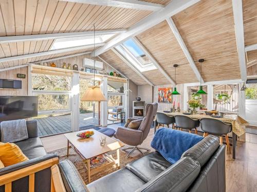a living room with a couch and a table at Holiday Home Gunde - 300m to the fjord by Interhome in Hemmet