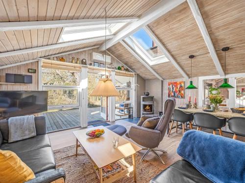 a living room with a couch and a table at Holiday Home Gunde - 300m to the fjord by Interhome in Hemmet