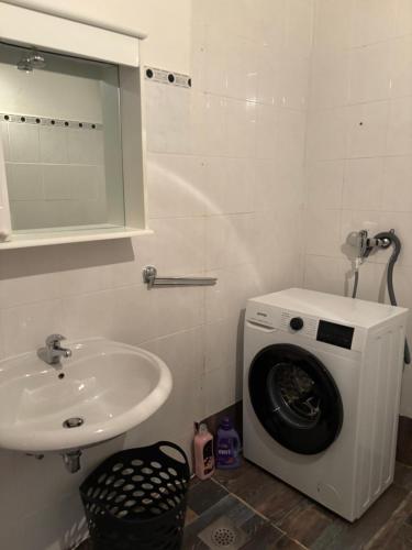 a bathroom with a washing machine and a sink at Rooms Marijeta in Skradin