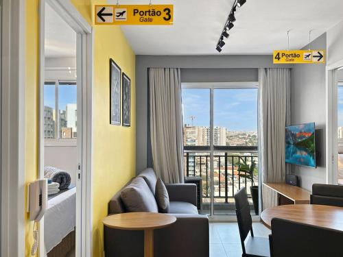 a living room with a couch and a table at 2 quartos - AC - Home office - WiFi in Água Boa