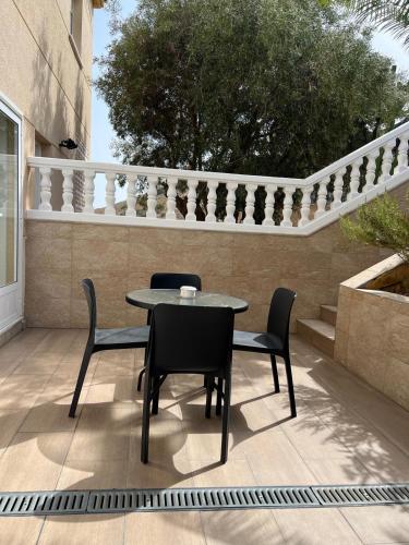 a table and chairs sitting on a patio at Roger's house frente al mar en Alicante in Gran Alacant