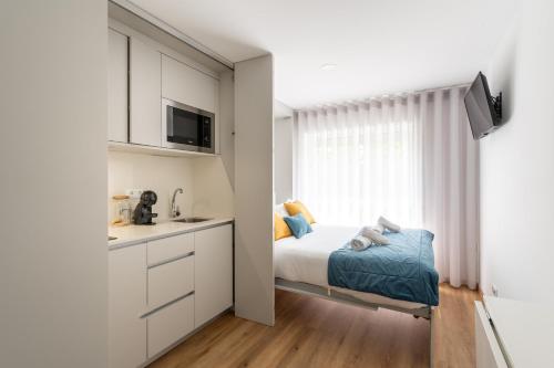 a small bedroom with a bed and a window at Lotus in Aveiro