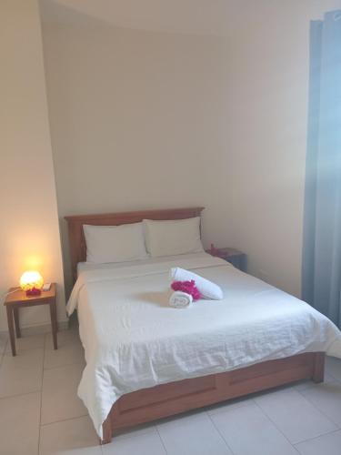 a bedroom with a bed with a stuffed animal on it at Mira lune villa in Flic-en-Flac