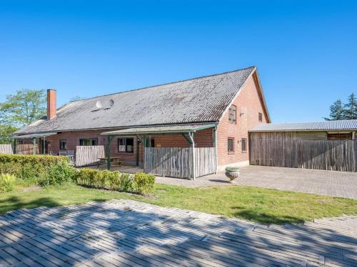 an old red brick building with a fence in front of it at Apartment Gertraude - 17km to the fjord by Interhome in Skjern