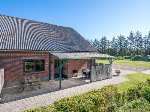a brick house with a picnic table and a roof at Apartment Gertraude - 17km to the fjord by Interhome in Skjern