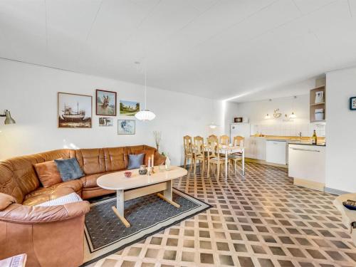 a living room with a couch and a table at Apartment Gertraude - 17km to the fjord by Interhome in Skjern