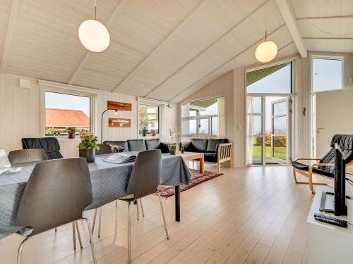 a living room with a table and chairs at Holiday Home Duschanka - 50m to the inlet by Interhome in Fredericia
