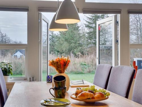 a dining room table with a plate of food on it at Holiday Home Daina - 400m to the fjord by Interhome in Vemb