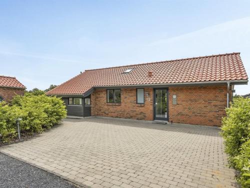 a brick house with a driveway in front of it at Holiday Home Donka - 300m to the fjord by Interhome in Skjern