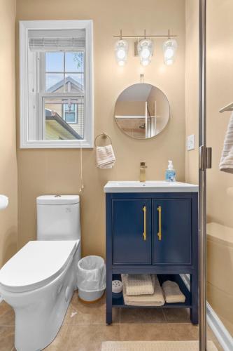 a bathroom with a blue cabinet next to a toilet at Beachfront Apartment - 8 min from downtown in New Haven