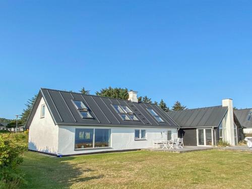a house with a solar roof on top of it at Holiday Home Alkmar - 75m from the sea by Interhome in Thisted