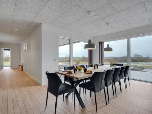 a dining room with a table and black chairs at Holiday Home Etje - 6km from the sea by Interhome in Ulfborg