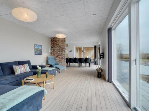 a living room with a couch and a table at Holiday Home Etje - 6km from the sea by Interhome in Ulfborg