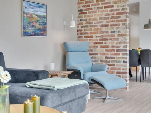 a living room with a couch and two chairs at Holiday Home Etje - 6km from the sea by Interhome in Ulfborg