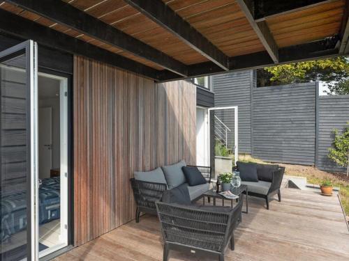 an outdoor patio with chairs and a table at Holiday Home Herewardus - 10m to the fjord by Interhome in Børkop