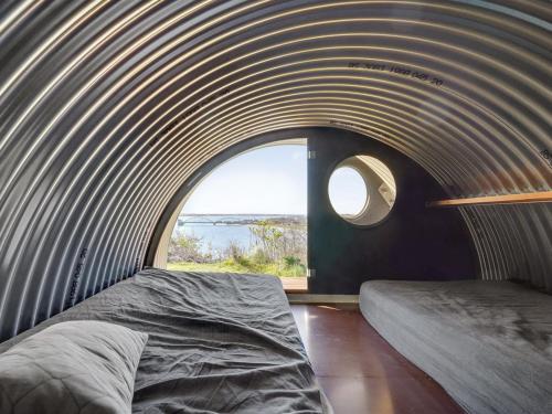 a circular room with a bed and a window at Holiday Home Nielsen - 30m to the fjord by Interhome in Thisted