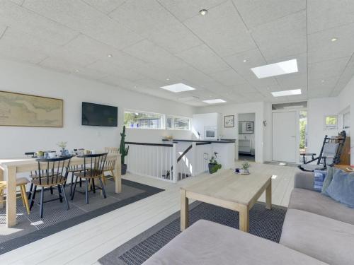 a living room with a couch and a table at Holiday Home Herewardus - 10m to the fjord by Interhome in Børkop