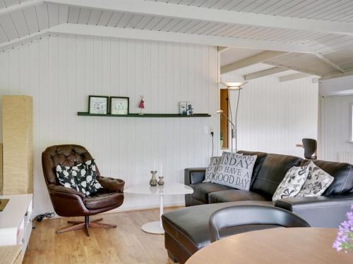 a living room with a couch and a table at Holiday Home Algot - 100m to the inlet by Interhome in Børkop