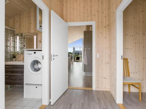 a laundry room with a washer and dryer in a house at Holiday Home Clement - 500m to the fjord by Interhome in Skjern