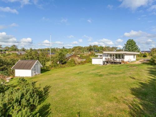 a large yard with a white house in the background at Holiday Home Tomine - 500m to the fjord by Interhome in Struer