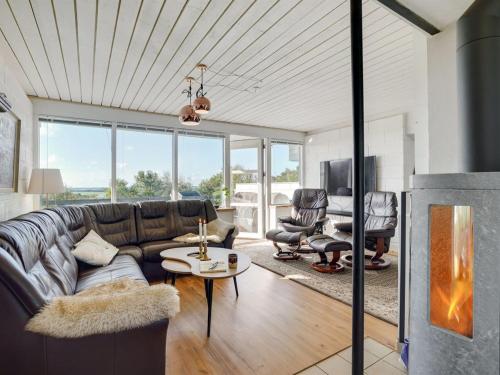 a living room with a couch and a table at Holiday Home Tomine - 500m to the fjord by Interhome in Struer