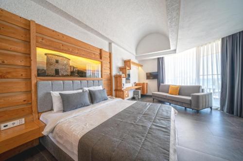 a large bedroom with a large bed and a chair at MyElla Boutique Hotel in Mugla
