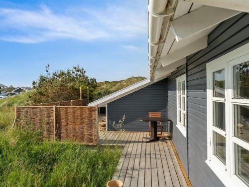 a patio with a table next to a house at Holiday Home Wulfhard - 400m from the sea by Interhome in Frøstrup