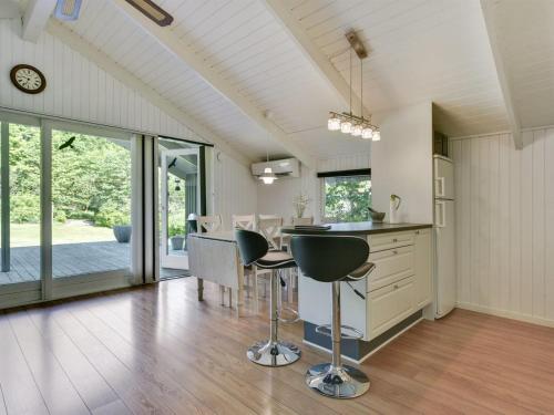 a kitchen and dining room with a table and chairs at Holiday Home Yngve - 56-5km from the sea by Interhome in Give