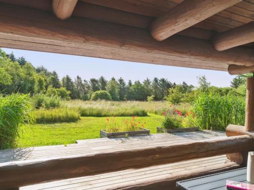 a view from the deck of a cabin with flowers at Holiday Home Elsia - 1-5km to the fjord by Interhome in Frøstrup