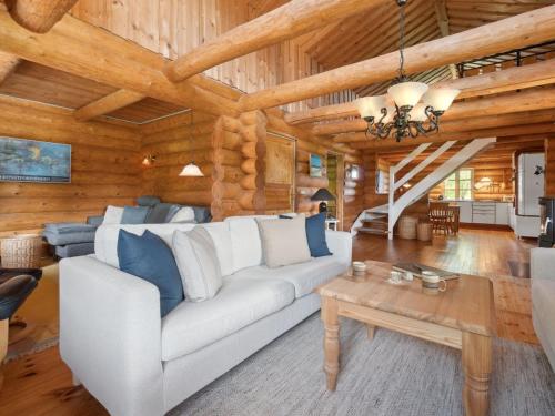 a living room with a white couch and a table at Holiday Home Elsia - 1-5km to the fjord by Interhome in Frøstrup