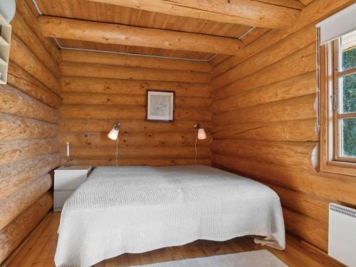 a bedroom in a log cabin with a bed at Holiday Home Elsia - 1-5km to the fjord by Interhome in Frøstrup