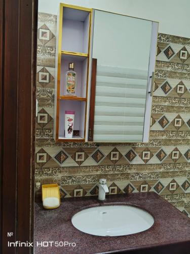 a bathroom with a sink and a mirror at Street 7 Apartment in Bahawalpur