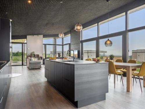 an open kitchen and dining room with a table and chairs at Holiday Home Anelle - 500m from the sea by Interhome in Børkop