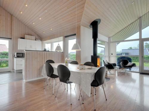 a kitchen and dining room with a table and chairs at Holiday Home Nine - 200m from the sea by Interhome in Børkop