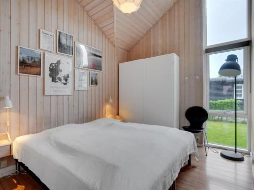 a bedroom with a white bed and a window at Holiday Home Nine - 200m from the sea by Interhome in Børkop