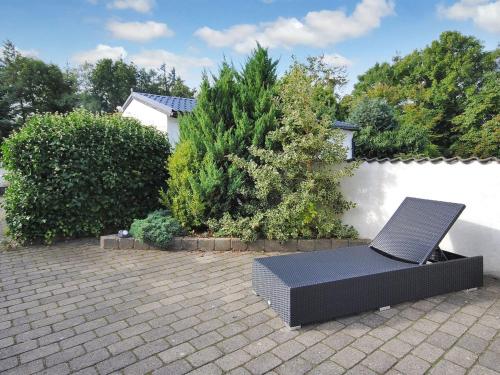a black chair sitting on top of a patio at Holiday Home Sophia - 8km from the sea by Interhome in Thisted