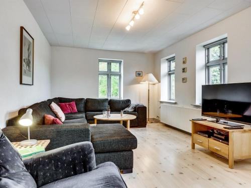 a living room with a couch and a flat screen tv at Holiday Home Sophia - 8km from the sea by Interhome in Thisted